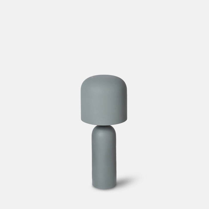 A cutout of the Sefton Table Lamp. A sleek matte sage metal table lamp with curved shade and smooth tapered base.