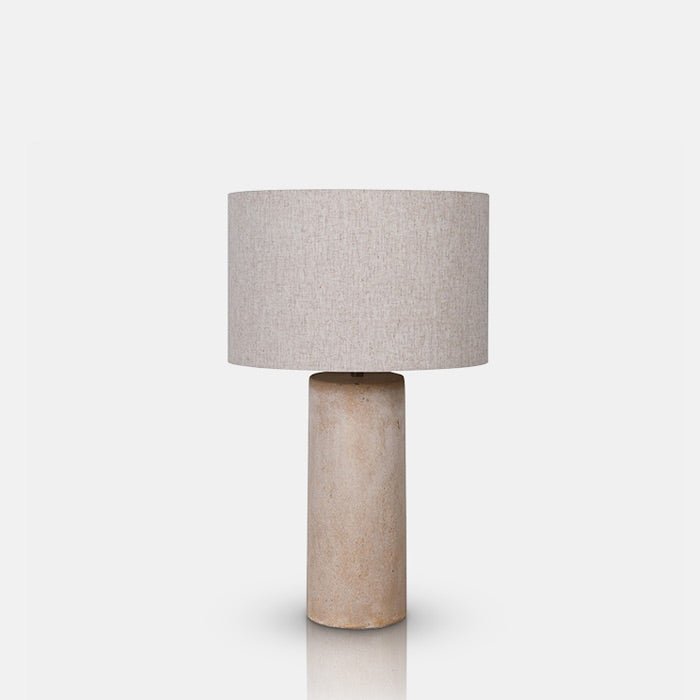A cutout of the Sennen Table Lamp, with a mottled cream coloured fibreglass base and a cream coloured drum shade.