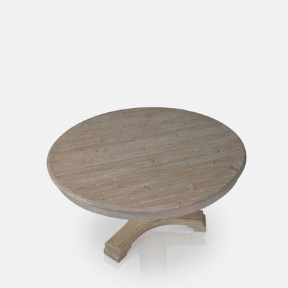 Round wooden dining table in a light brown with a pedestal base