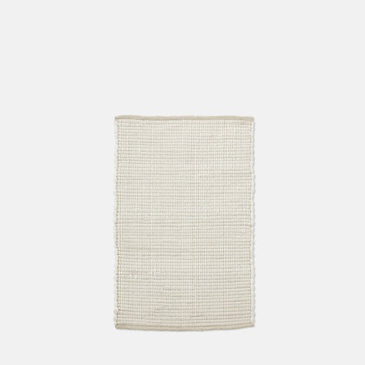 Small flat weave cotton rug in ecru white.