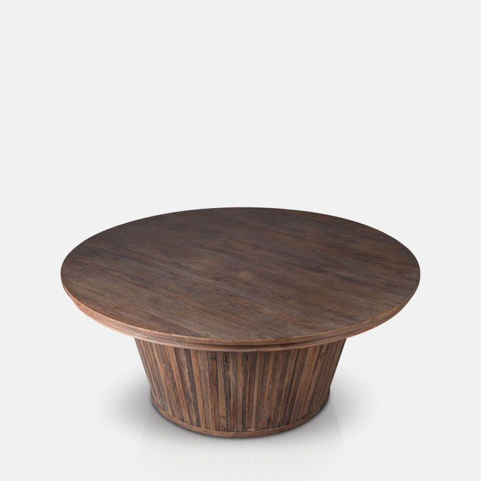 Large round wooden dining table with a dark stain