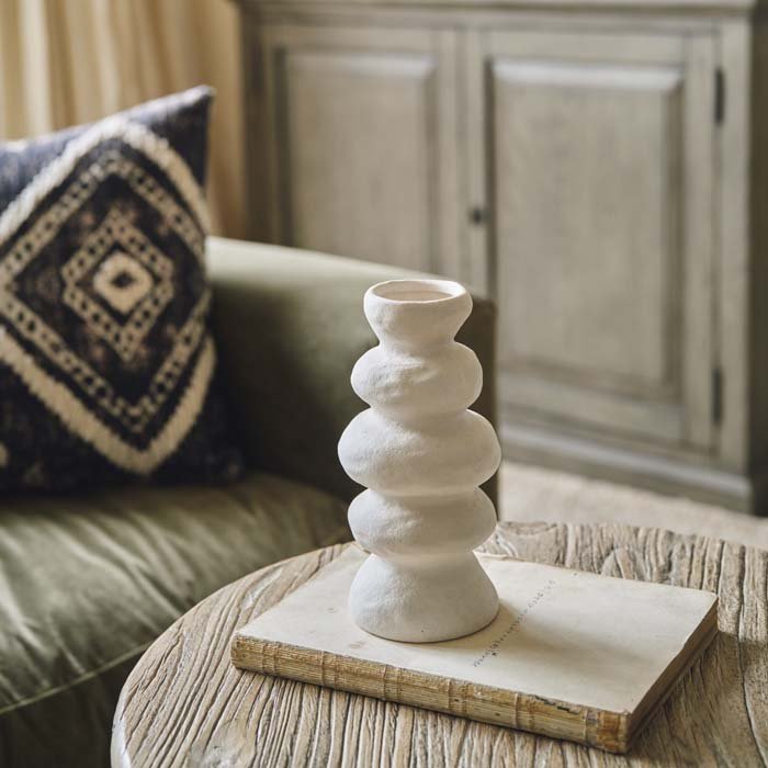 Tall cream vase in a wavy shape with a narrow neck. Can be styled with faux flowers and dried grasses for a natural look in your home. 