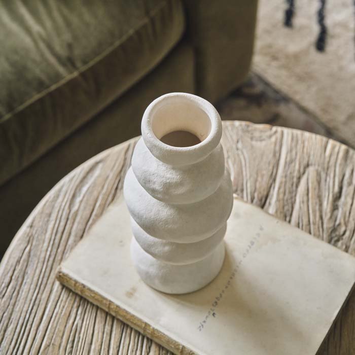 A wavy artisan style vase in a light cream colour with a narrow neck. Modern shaped vase to add a unique style in your dream home.