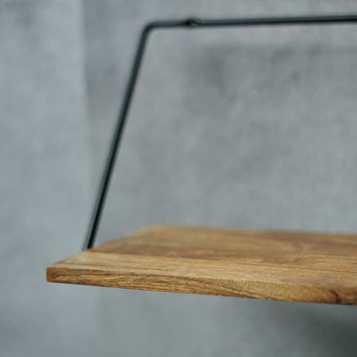 Dark wooden shelf sat on a thin black iron frame