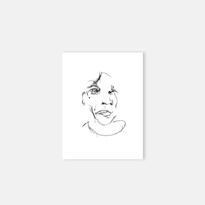  Black line drawing of a face on white paper