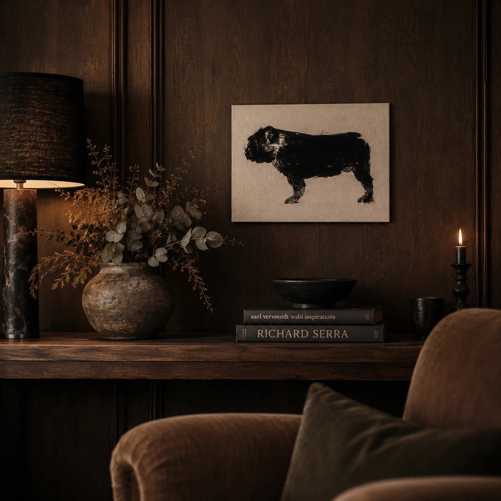 Tank Dog Print featuring a black dog silhouette on a pale ground, styled above a dark console with books, flowers and warm ambient table lighting.