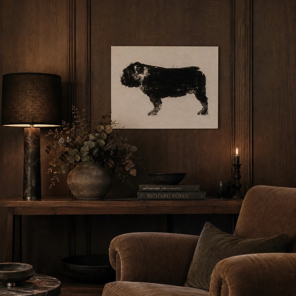 Tank Dog Print with black dog silhouette on a pale background, displayed above a dark console between warm lamps and neutral upholstered armchairs.