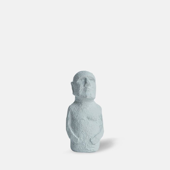 White figurine with arms on its waste and no lower body
