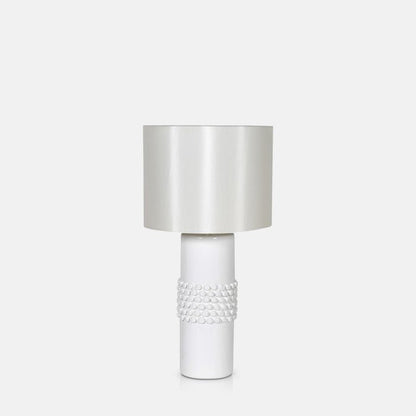 White table lamp with a spikey textured base and round lampshade