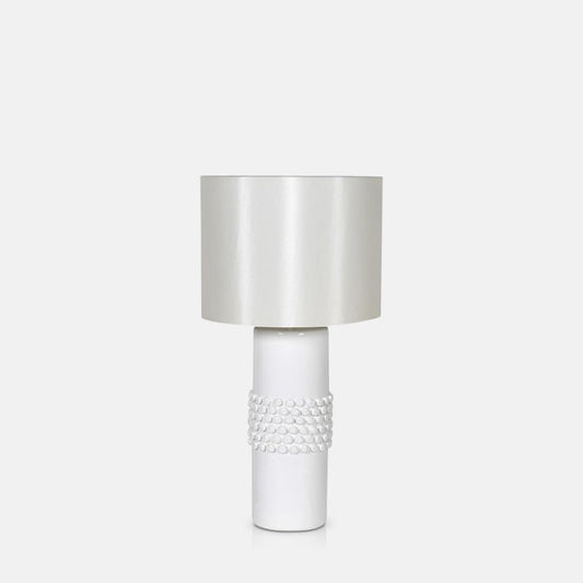 White table lamp with a spikey textured base and round lampshade