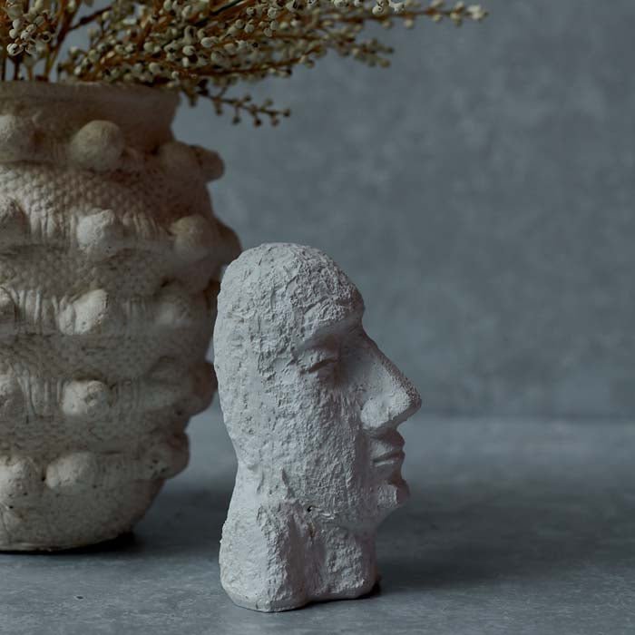 Side profile of a sculpted face in white