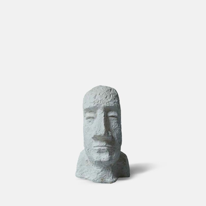 Face sculpture in white with a long face and large nose
