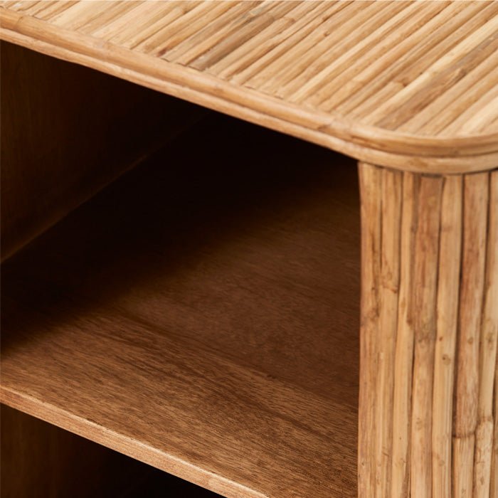 Two shelves inside natural brown rattan cabinet.