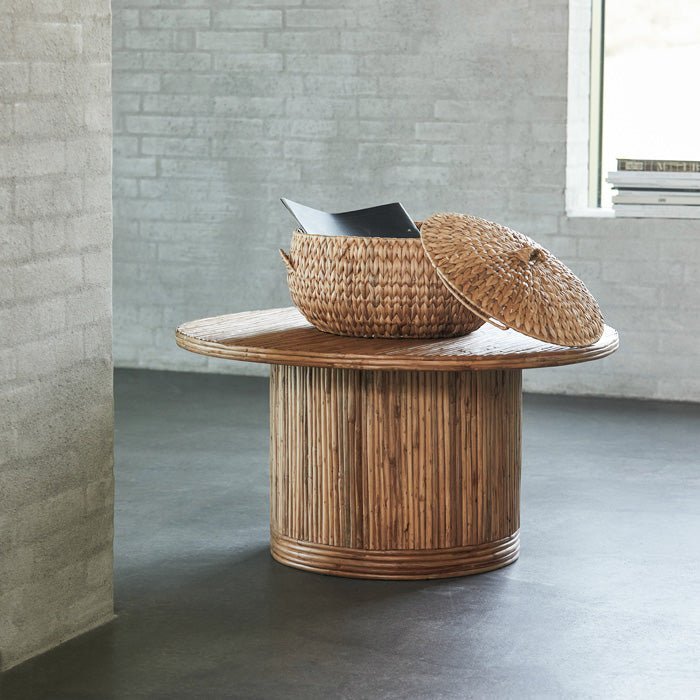 Tipton Coffee Table, a round rattan wood coffee table in warm natural brown colour, with a large woven basket on the top.