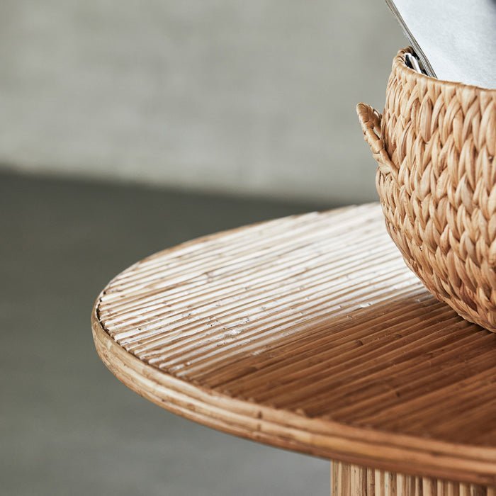 A closeup of the Tipton Coffee Table, a round rattan wood coffee table in warm natural brown colour.