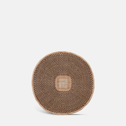 Round woven wall basket with black and natural pattern design.
