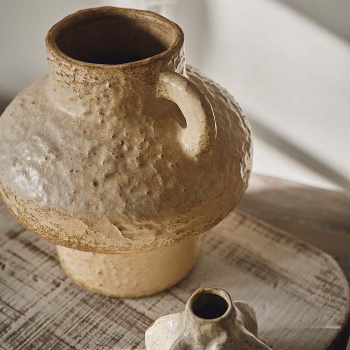 Large neutral coloured vase in an organic shape with a handle to one side and a large neck. Style with faux flowers or dried flowers to give your home a natural look. 