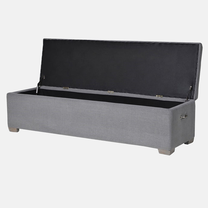 Vida Bedding Box, a rectangular storage trunk upholstered in a soft grey with a quilted style top panel, with the lid open.