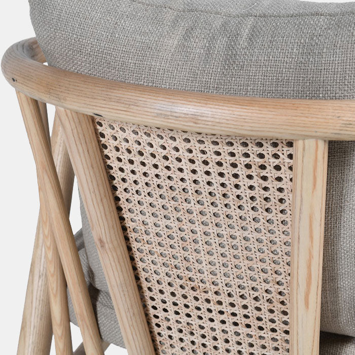 Curved wooden frame and rattan back of an armchair