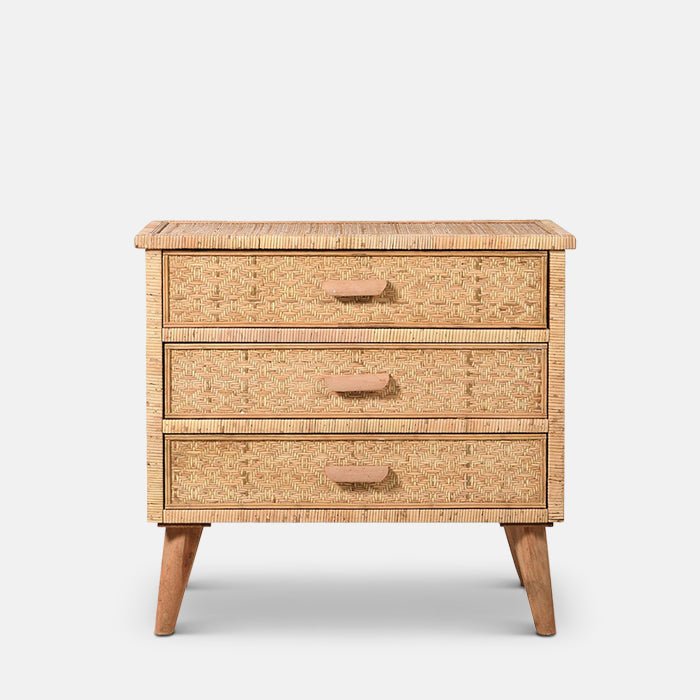 A cutout of light brown rattan chest of drawers with three drawers, wooden legs and wooden handles. With free delivery over £150.