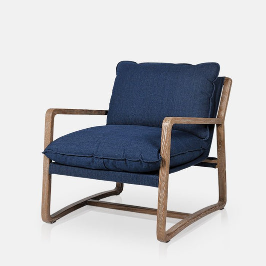A cutout of a denim fabric armchair with a light wooden frame. Contemporary armchair. Modern armchair. Sign up and get 15% off your first order, with free delivery over £150.