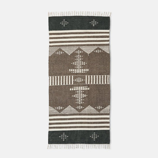 A cutout of a flat weave brown and black patterned runner with fringing. Shop now from Abigail Ahern, in homes since 2003.