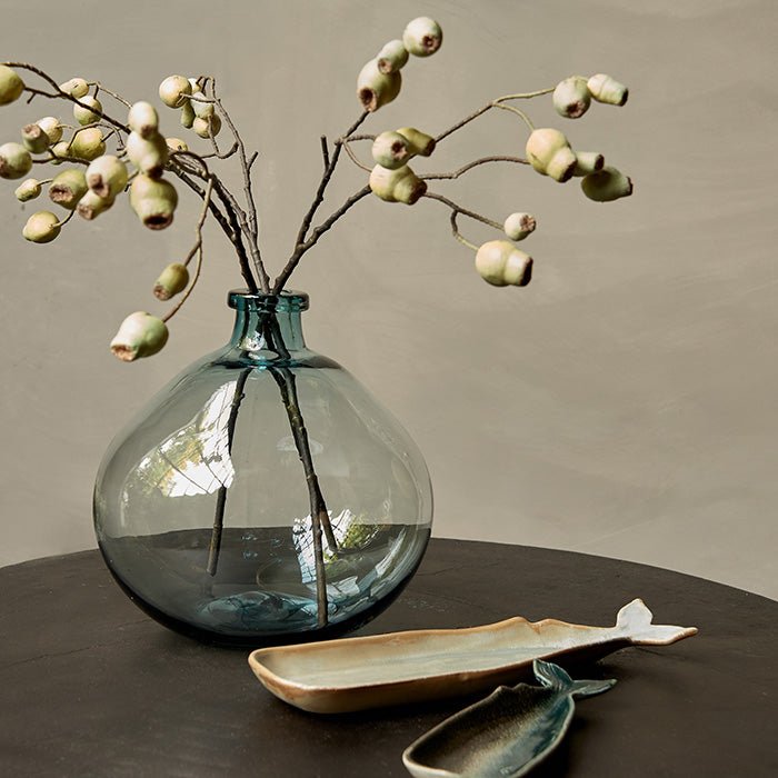 A vintage French style bottle vase in a light green colour. Can be styled with other home accessories and artificial grasses and flowers.