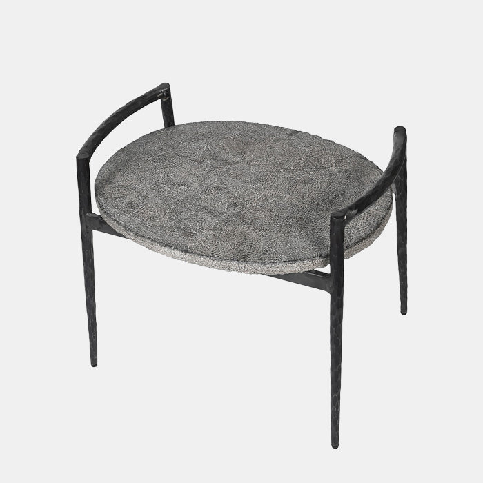 Cutout image of a modern end table with a stone table top on black legs. 