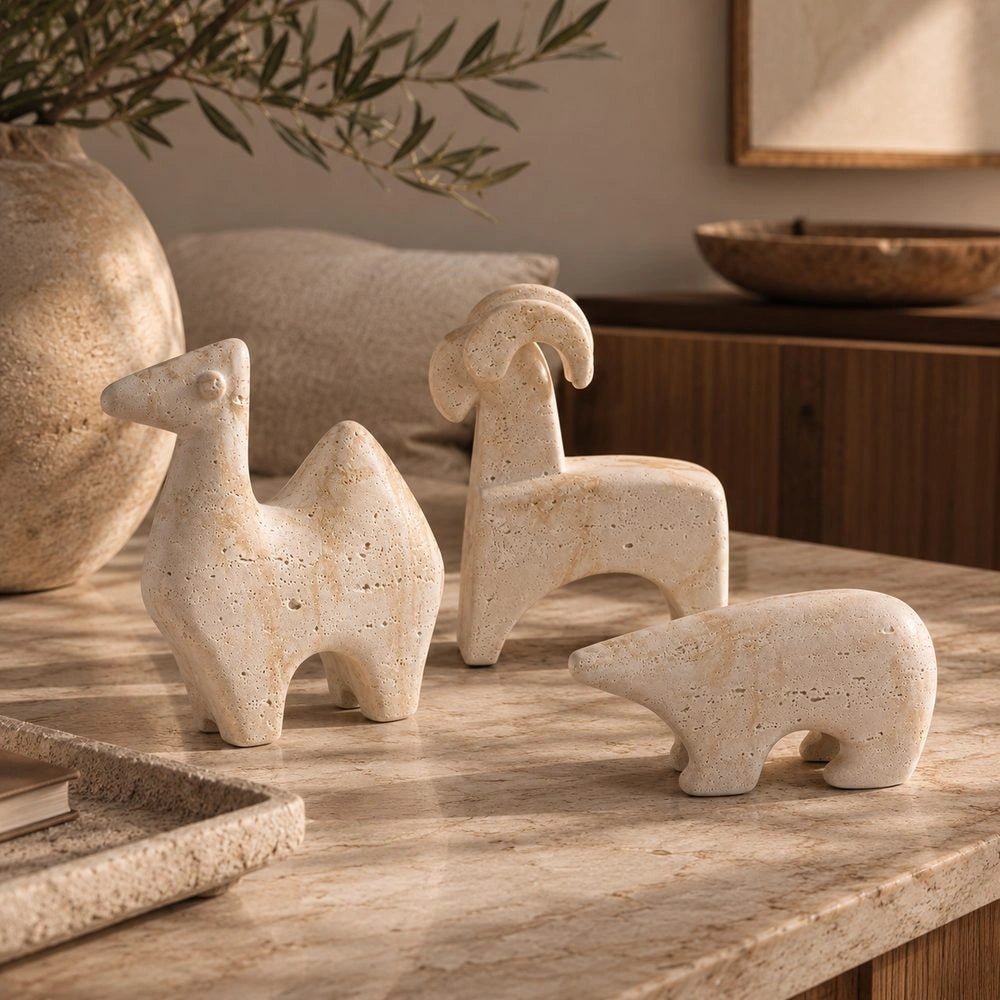 Animal Sculptures set of three abstract animal figures shown together from a side angle, with pale textured surfaces and distinctive sculptural silhouettes.