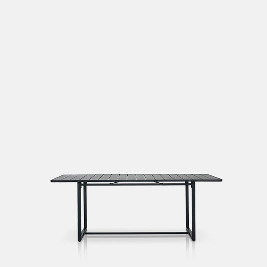 Cutout image on a white background of a black metal garden dining table. The garden dining table is rectangular and a classic shape.