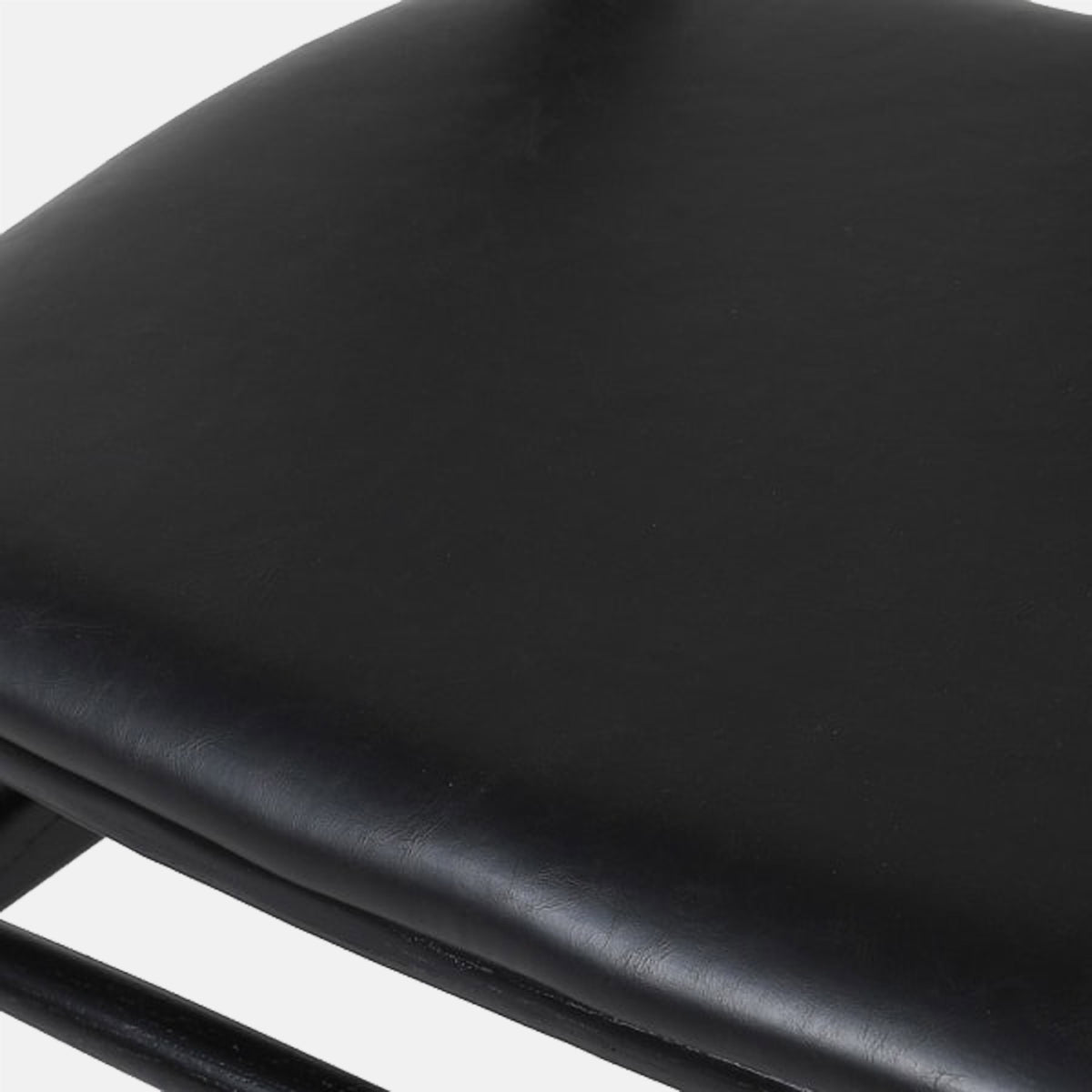 A closeup of the black seat pad of n the Avalon Wishbone Dining Chair.