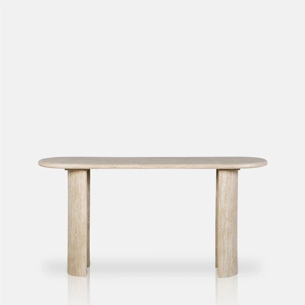 Barnard Travertine Console Table shown from the front, with a pale beige oval top, two substantial legs and visible natural stone texture.