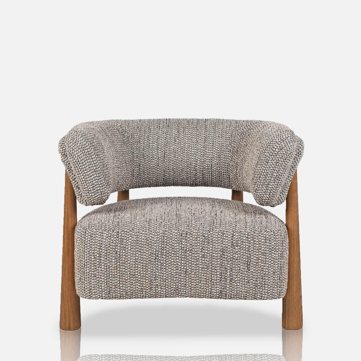 Abigail Ahern Bastian Curved Armchair in soft neutral textured upholstery, featuring a rounded vintage-inspired silhouette, generously padded seat and backrest, and natural ash wood legs.