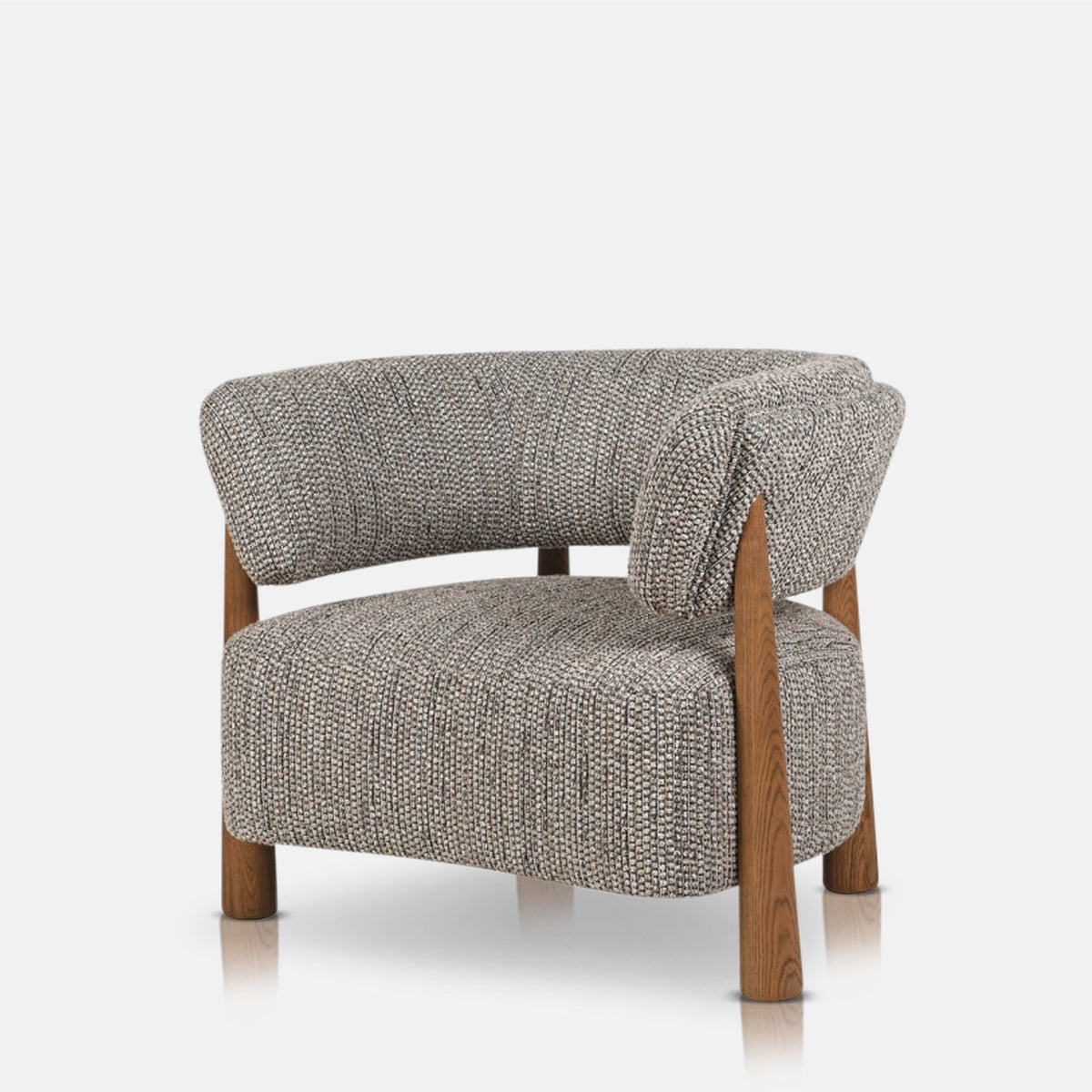 Abigail Ahern Bastian Curved Armchair with a generously cushioned seat, rounded upholstered back and soft neutral fabric, showcasing its elegant vintage-inspired shape in a warm modern living space.