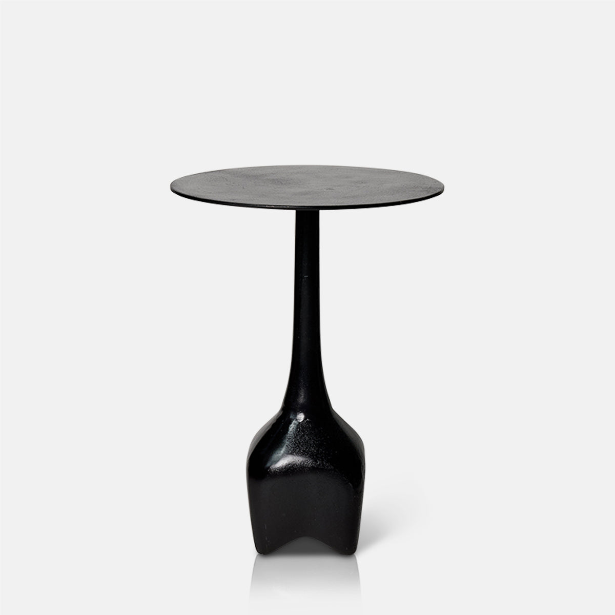 Cutout image on a white background of a black, round metal side table with a narrow base.