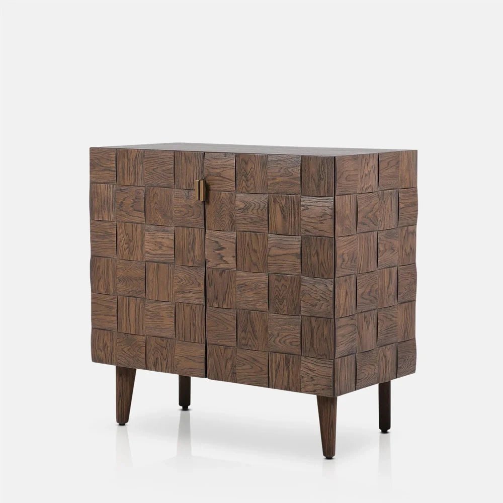 Bradley Wooden Cabinet with a warm brown finish, two doors patterned with raised square panels and four slim tapered legs, shown from an angled view.