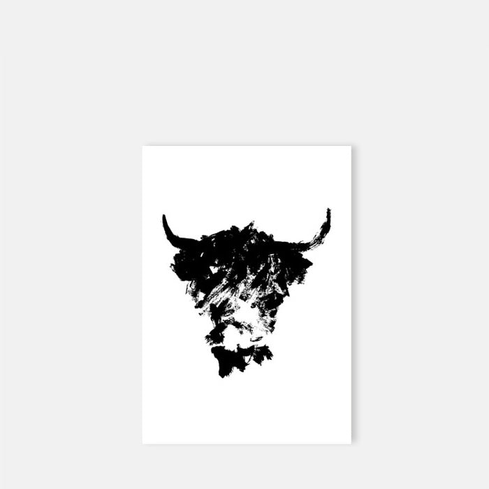 Abstract black brushstroke drawing of a shaggy cow on white paper