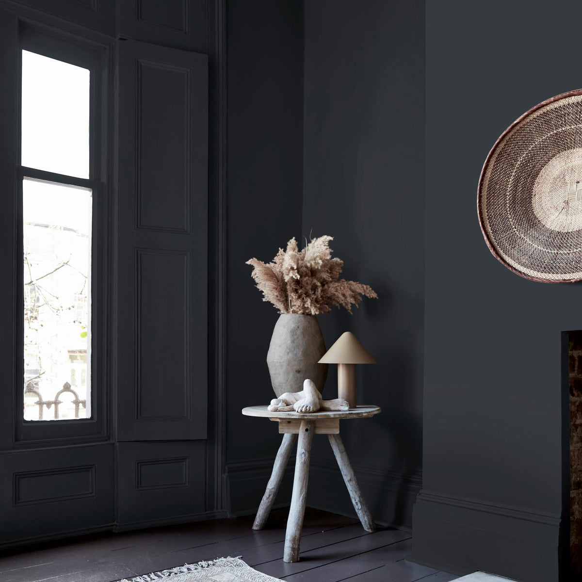 Abigail Ahern Broome Coast paint – a sumptuous dark teal enveloping a beautifully styled corner with side table, vase and lamp