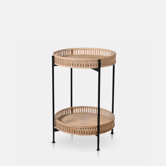 A cutout of the Casoni Bamboo Side Table, a 2-tiered bamboo side table with a black frame and a boho vibe