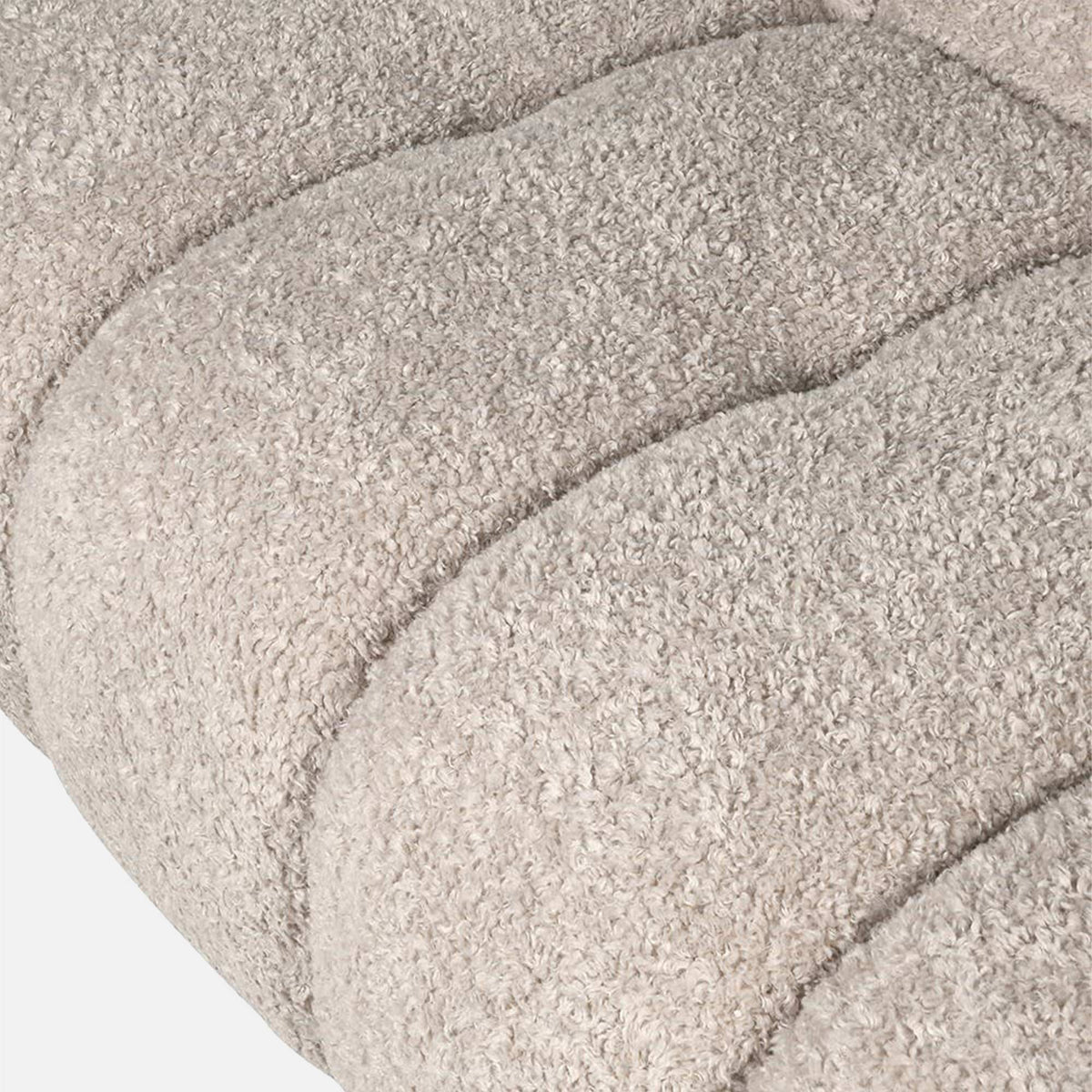 Close up - Luxury beige 3 seater sofa with a plush upholstered finish and sculptural modern silhouette. Cheverell 3-Seater Sofa by Abigail Ahern, designed with a soft neutral fabric and generous proportions for ultimate comfort and relaxed living. A statement contemporary sofa perfect for modern living rooms, luxury interiors and cosy lounge spaces, adding timeless elegance, texture and sophisticated style to your home decor.