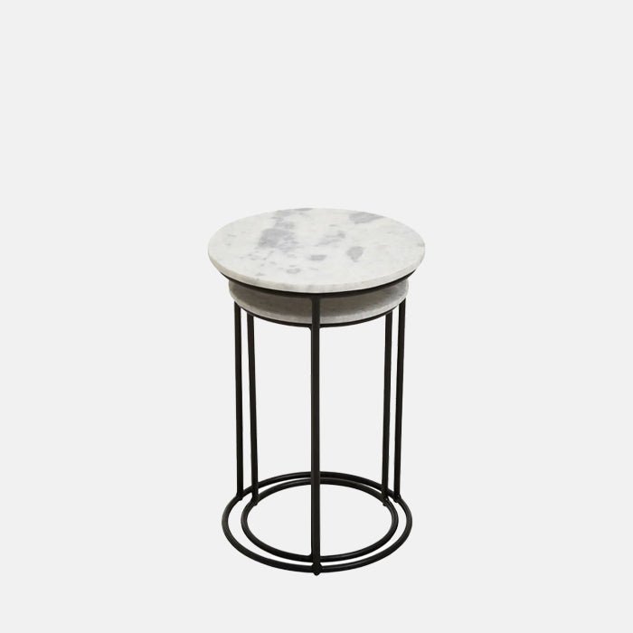 The Danan Nesting Side Tables, a set of two small round tables with white marble tops and black legs, one slightly smaller.