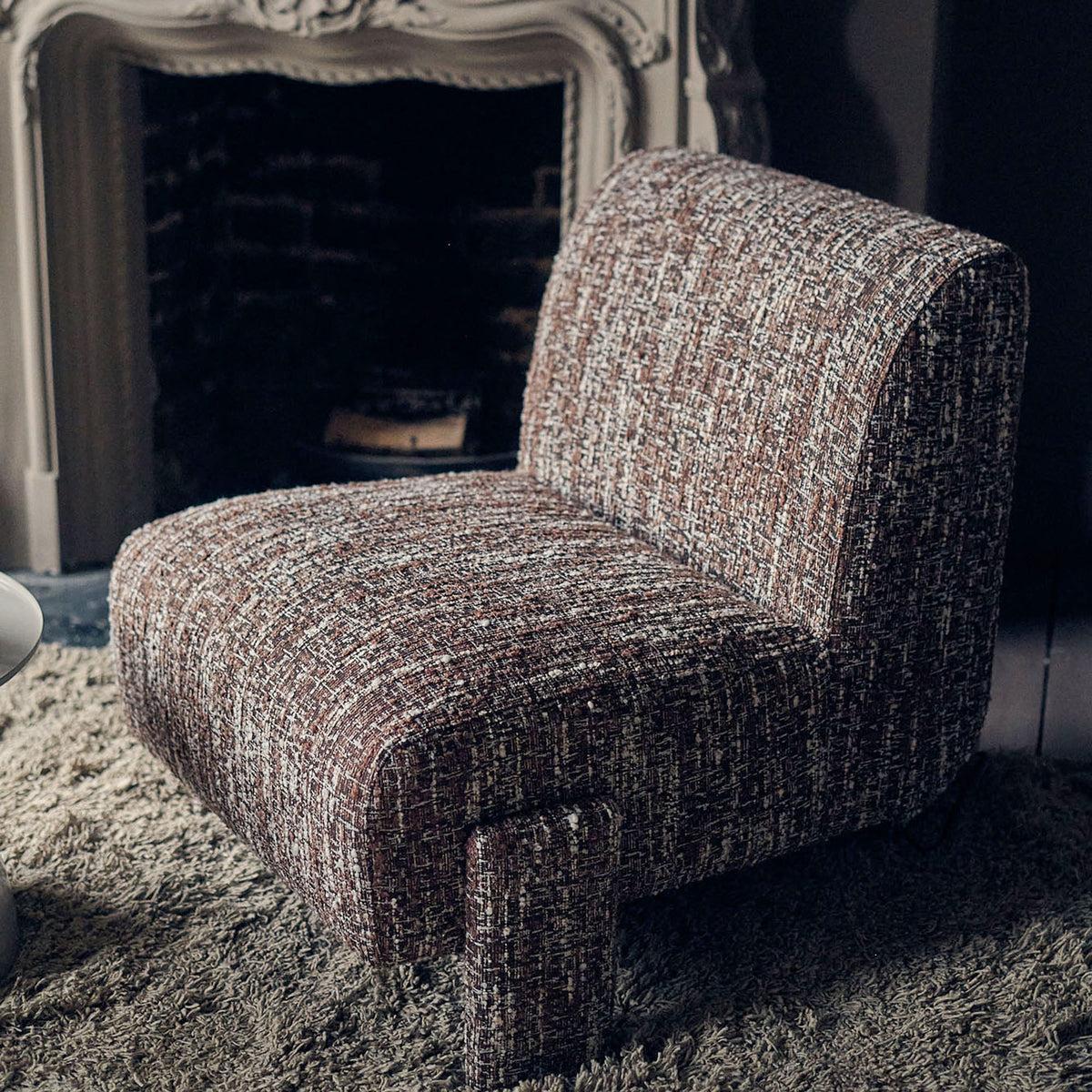 Abigail Ahern Darell Boucle Accent Chair in a rich earthy brown textured boucle fabric, featuring a generously rounded silhouette, softly curved arms and plush upholstered seat, styled as a warm statement piece in a sophisticated modern interior.
