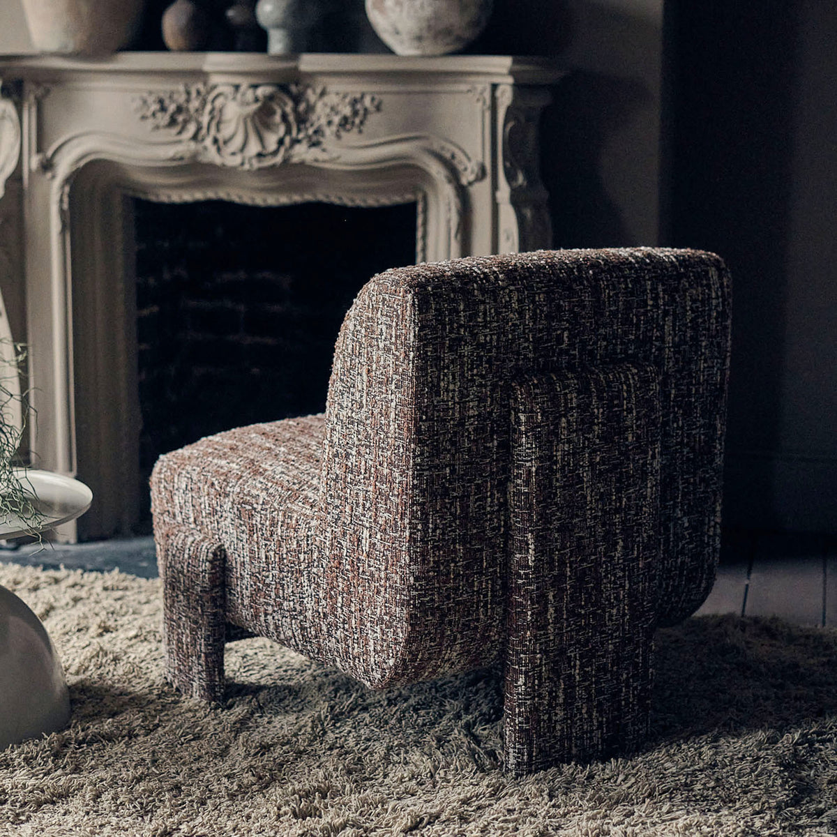 Close-up of the Abigail Ahern Darell Boucle Accent Chair highlighting the rich earthy brown boucle upholstery, soft tactile texture and plush finish of the curved upholstered seat and back.