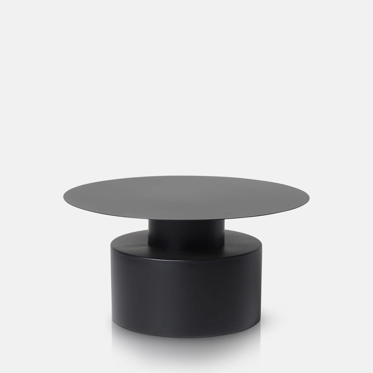 Abigail Ahern Denholm Round Coffee Table in dark black iron with a raw, but smooth finish and contemporary silhouette, creating a bold centrepiece for modern living rooms.