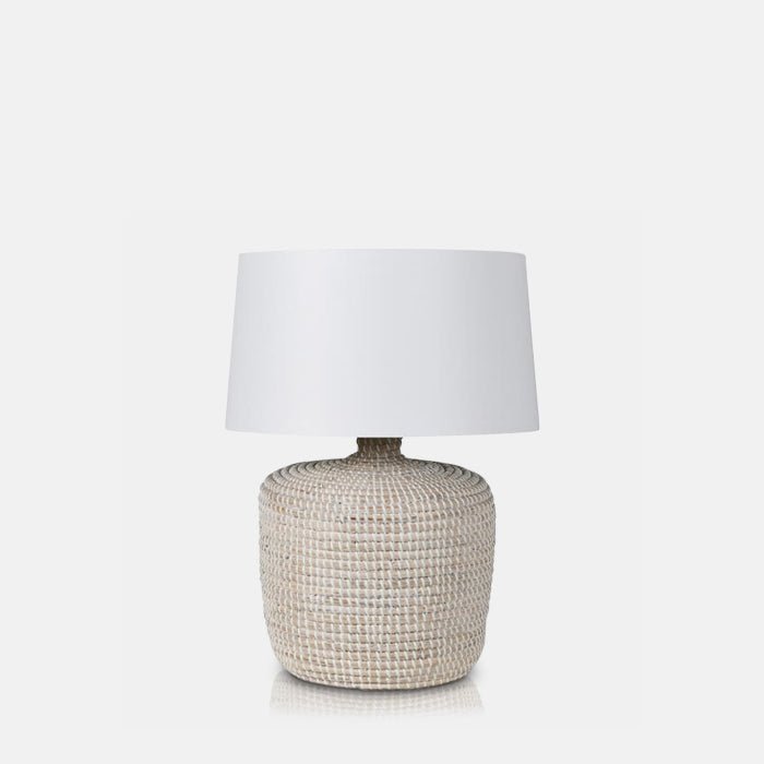Cutout of Devoran Seagrass Lamp, a table lamp with a chunky cylindrical base made from natural seagrass and white drum shade.