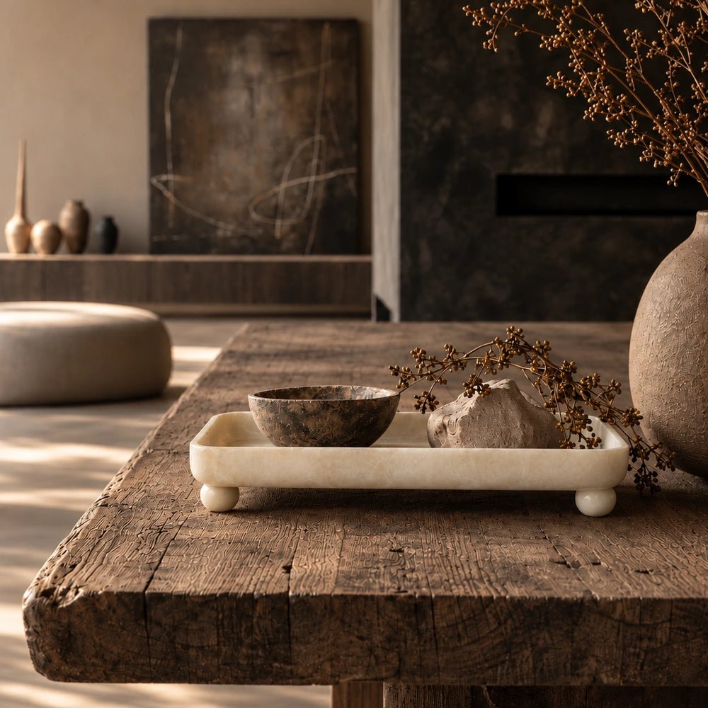 Diego Footed Tray with elevated sculptural shape, styled on a warm console with layered decorative accessories and natural contemporary interior textures.