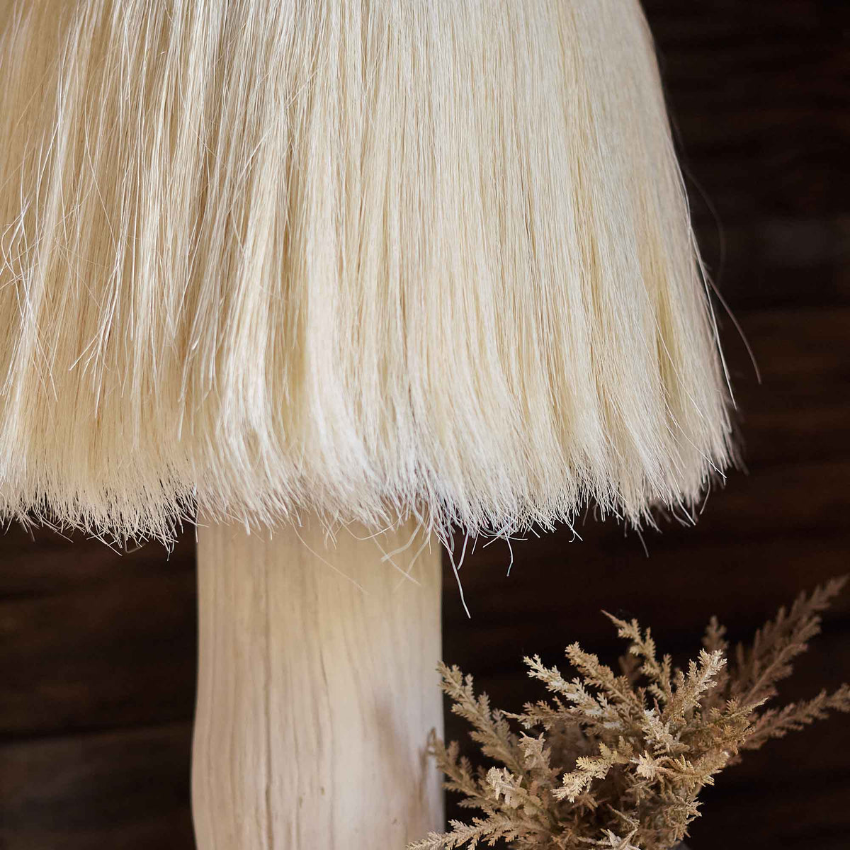 A closeup of the cream coloured Sisalana fibre fringed shade of the Dolan Table Lamp.