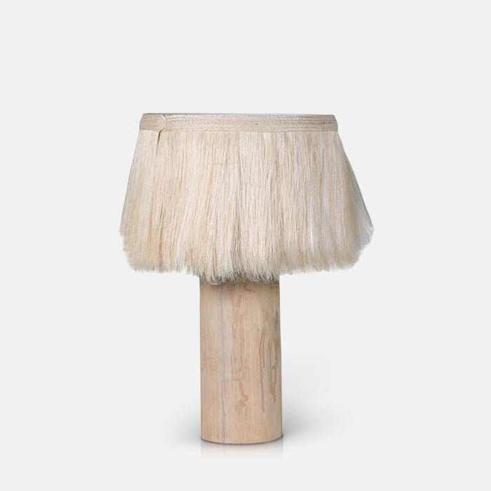 Cutout of the Dolan Table Lamp, a lamp with natural wooden base and an unusual cream fringed shade made from sisalana fibre.
