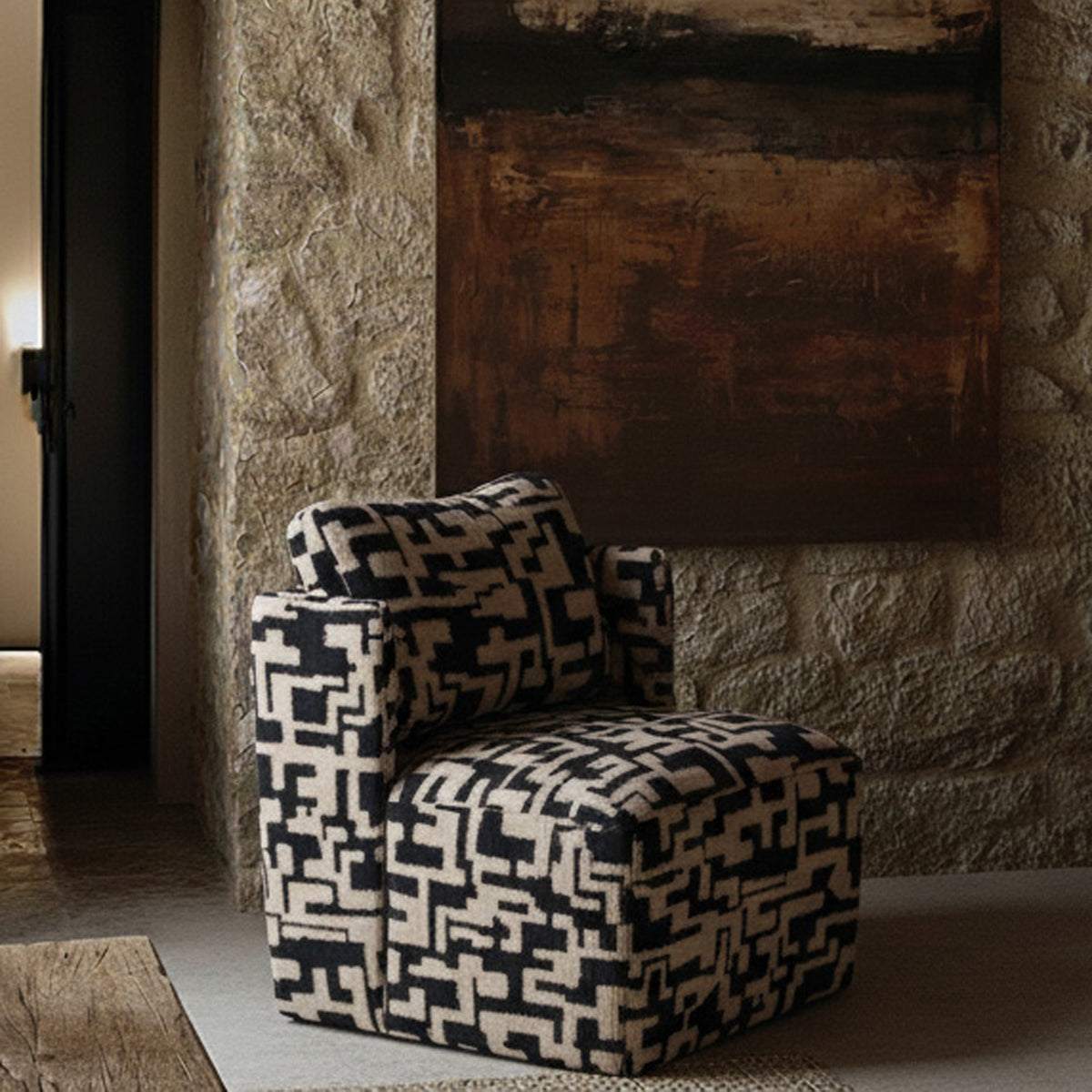 Black and beige patterned armchair with an abstract geometric print, plush upholstered seat and contemporary boxy silhouette. Dulwich Patterned Armchair by Abigail Ahern, designed as a bold statement accent chair that adds personality and texture to modern living rooms, bedrooms and stylish interiors. A luxury occasional chair perfect for creating a designer focal point, combining comfort, pattern and timeless contemporary style in your home decor.