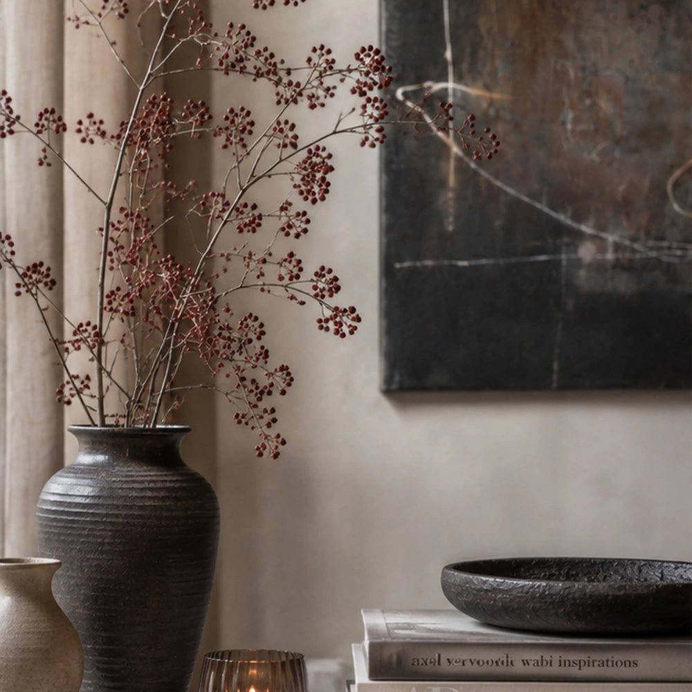 Flicker Canvas Art with expressive black and cream abstract forms displayed above a console, styled with sculptural objects in a warm neutral interior.